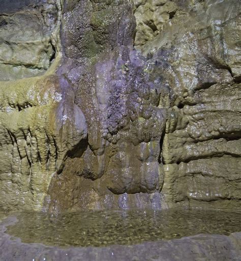 Geological Rock Formations And Water Pool In An Underground Cave Stock