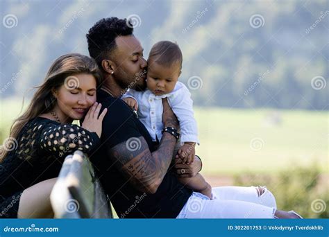 Multiethnic Parents Biracial Baby In Park Multiracial Couple Outdoor