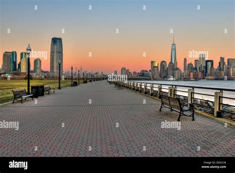 Jersey City And Manhattan Skylines At Sunset Liberty State Park