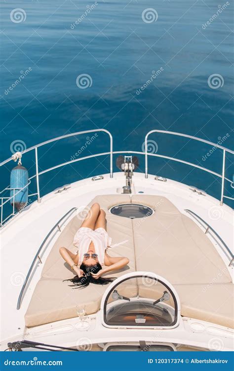 Appealing Woman Tanning On Yacht Enjoying Sunlight Posing On Deck Of