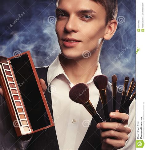 Professional Makeup Artist Posing In Studio Holds A Palette Of Shadows