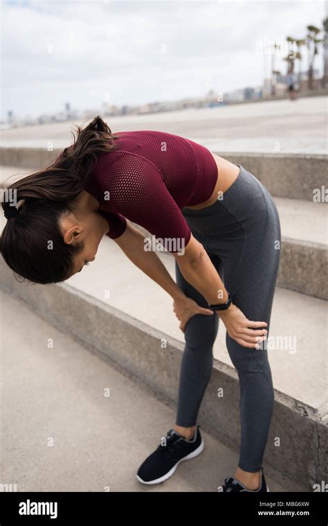 Sporty Woman Taking A Break After Exercising In Her Grey Tights And