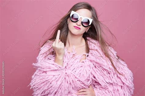 nervous outraged posh diva with linked teeth gestures fuck you in anger being irritated on