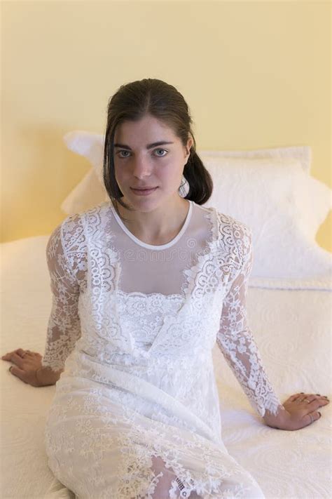 Brunette Girl Wearing Long White Lace Dress Sitting On Bed Stock Image Image Of Vertical