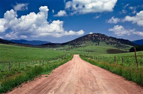 Dusty Road Through Green Hilly Pasture Land Stock Photo Image Of