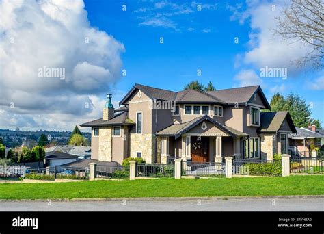 Big Residential House On Bluesky Background With Metal Fence In Front
