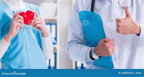 Cardiologist With His Nurse Assistant Posing In Hospital Stock Photo