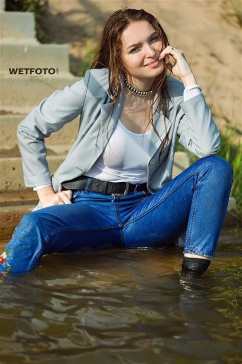 wetlook by gorgeous girl in wet tight jeans blouse and jacket on the lake wetlook one