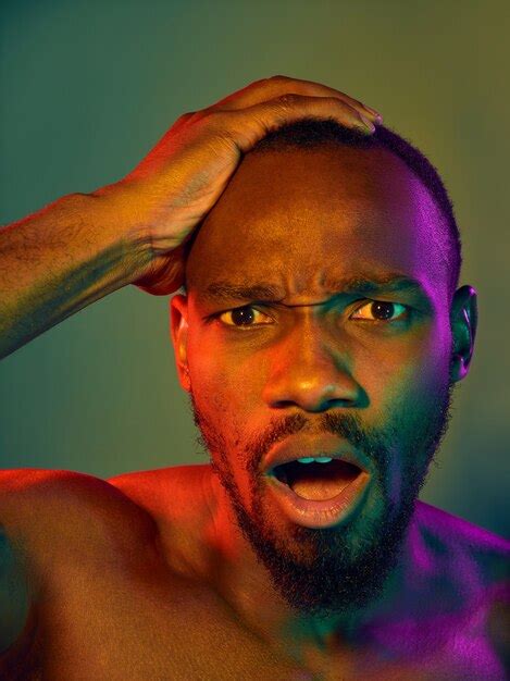 Premium Photo Close Up Portrait Of A Young Naked African Man Looking At Camera Indoors