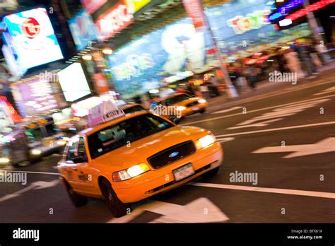 Yellow Taxi Cab At Night In Times Square New York Stock Photo Alamy