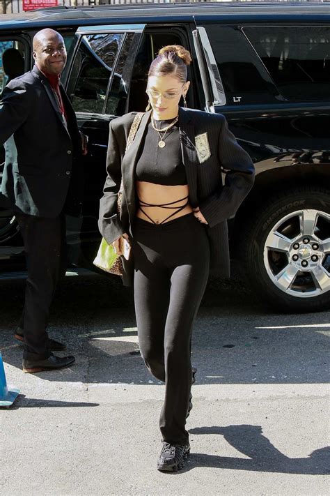 bella hadid flaunts her toned abs in a black crop top with an all black ensemble as she steps