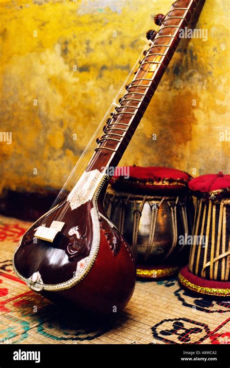 Indian Musical Instruments A Sitar And Tabla Dagga Drums On Carpet