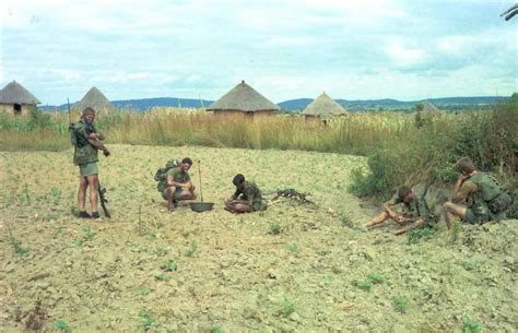 Rhodesian Light Infantry Troops Picking Up Beans In A Field While On