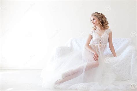 Beautiful Girl In Lingerie Sitting On A White Couch Wedding Stock Image