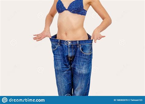 Woman Shows Weight Loss In Old Big Jeans Stock Photo Image Of Loose