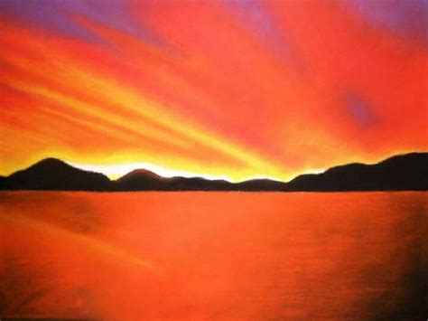 An Orange And Purple Sunset Over Water With Mountains In The Background