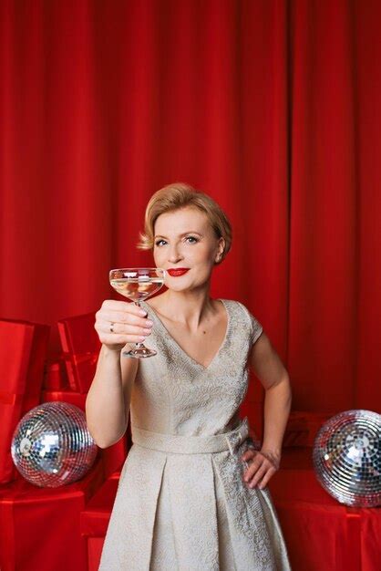 Premium Photo Mature Stylish Elegant Woman In Cocktail Dress With Glass Of Sparkling Wine With