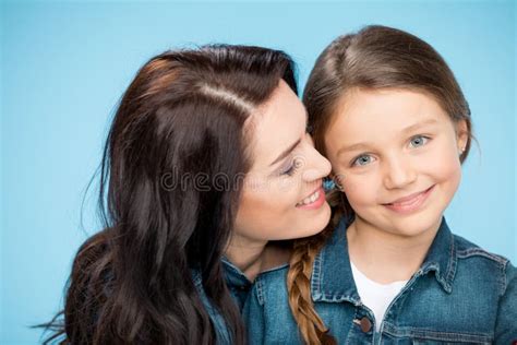 Happy Mother And Daughter Hugging In Studio On Blue Stock Image Image