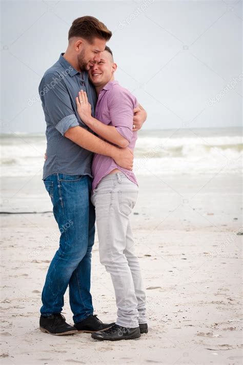 Gay Men Embracing On A Beach Stock Photo By ©danedwards 127719156