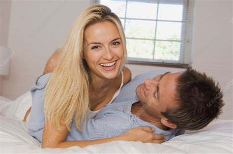 smiling couple hugging in bed stock image f004 1050 science photo library