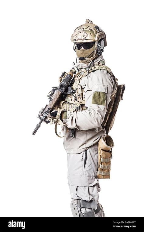 army soldier in protective combat uniform holding special operations forces combat assault rifle