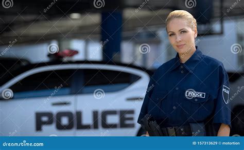 Female Police Officer Smiling Standing Near Patrol Car Maintenance Of