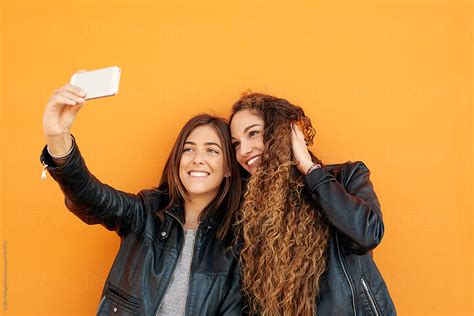 two attractive girlfriends taking selfie by stocksy contributor guille faingold stocksy