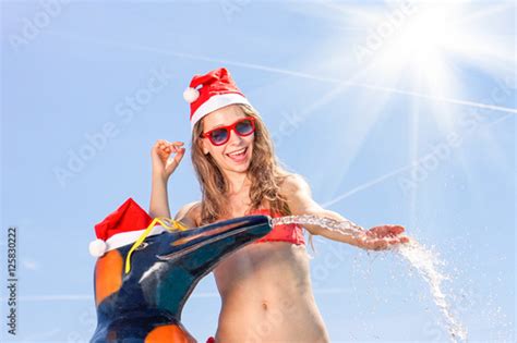 Happy Santa Claus Woman In Red Bikini Playing With Water Spring On The