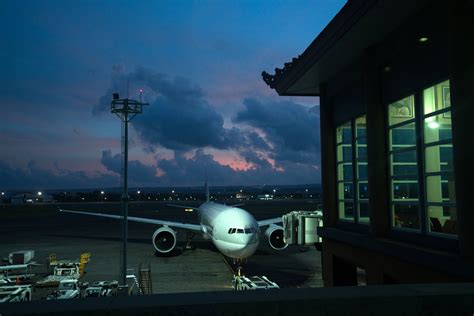 Aircraft Parked Near Airport Terminal At Night · Free Stock Photo