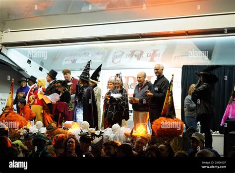 Group of people in Halloween costumes standing on the stage during