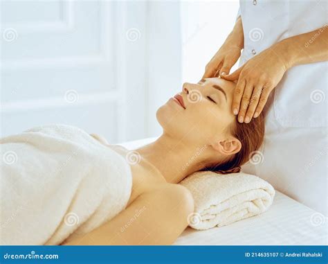 Beautiful Woman Enjoying Facial Massage With Closed Eyes In Spa Center Relax Treatment Concept