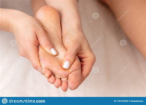 Close Up View Of Masseur Hands Making Foot Massage For Young Woman In
