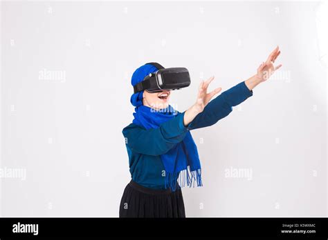 Asian Muslim Woman Wearing Hijab Using Vr Headset Glasses Of Virtual Reality On White Background