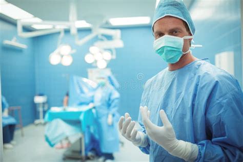 Portrait Of Male Surgeon Wearing Surgical Mask In Operation Theater