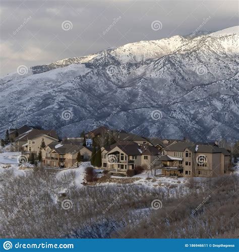 Square Pristine Landscape Of Wasatch Mountains With Houses On Its Snow