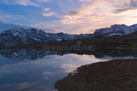High Altitude Alpine Lake In Idyllic Landscape Reflection Of