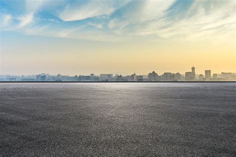 City Skyline And Buildings With Empty Asphalt Road At Sunrise Stock