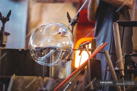 Glassblower Shaping A Glass On The Blowpipe At Glassblowing Factory — Worker Working Stock