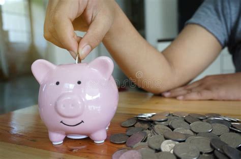 Woman Hand Putting Coin On Piggy Bank Saving Maney Concept Stock Photo