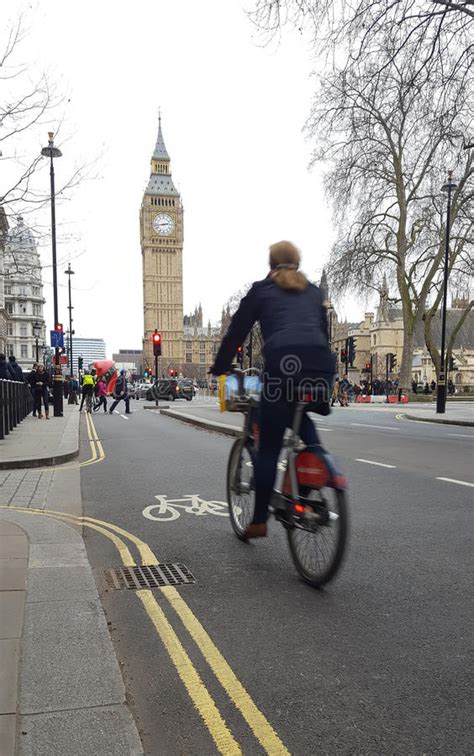 Woman With Bicycle Riding In Central London City Big Ben In Background