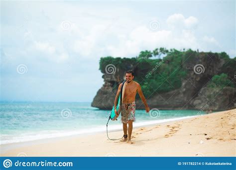 Surfer Surfing Man With Surfboard Walking On Sandy Tropical Beach