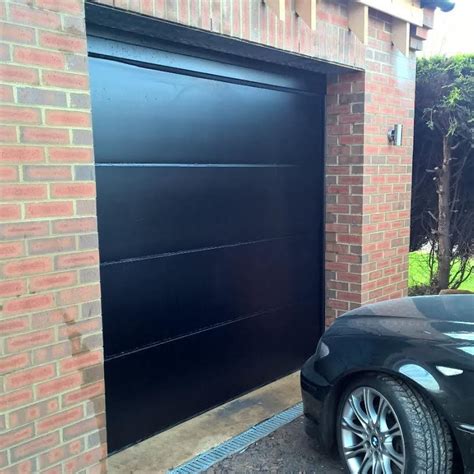 The length is the measurement of all the coils pressed together. iso45 Flush Smooth Sectional Garage Doors in Black - Elite GD