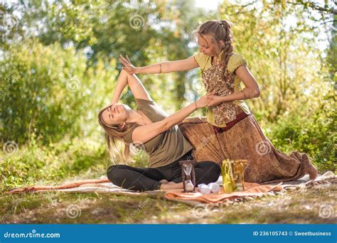 Master Massage Therapist Applies Her Massage Skills On Her Client In The Sunlight Stock Image