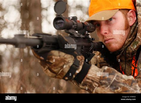 Hunter Aims Rifle While Deer Hunting Stock Photo Alamy