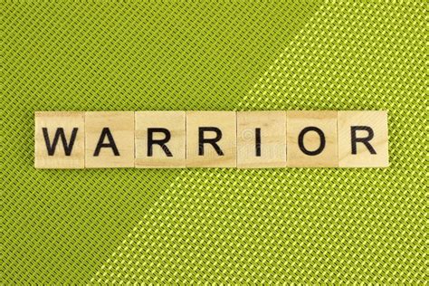 Warrior Word Of Wooden Letters On A Green Background Stock Photo