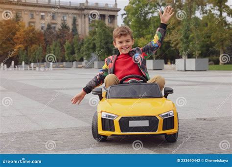 Cute Little Boy Driving Children S Car On City Street Stock Photo