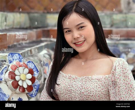 Pretty Thai Girl With Long Hair Smiles For The Camera At Bangkoks