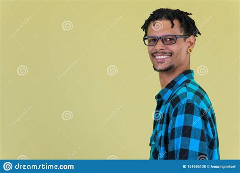 Profile View Of Young Happy African Hipster Man Smiling And Looking At