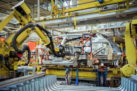 Robots With Car Body On Production Line In Car Factory Stock Photo