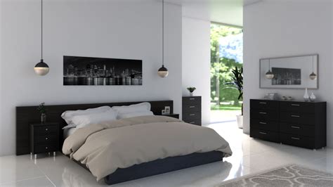 In this airy bedroom, white covers the floors, walls, and ceiling, but a charcoal bed skirt and dark wood furniture help ground the decor. 7 Best Wall Paint Color for Bedroom with Black Furniture - roomdsign.com